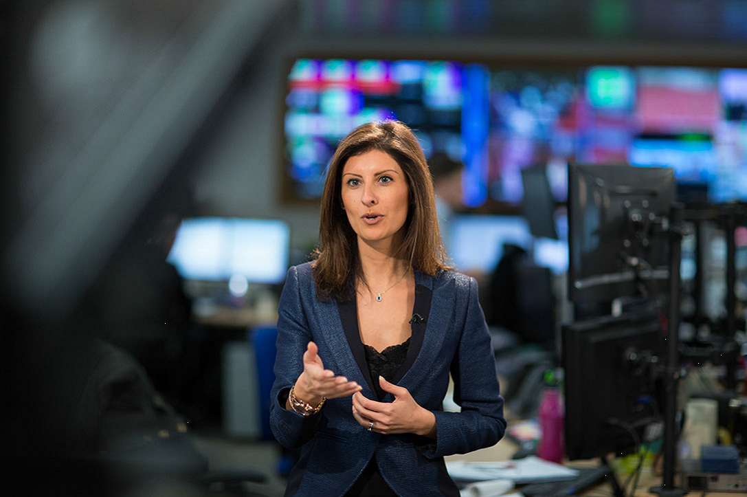Maryam Behmard presenting in a television newsroom